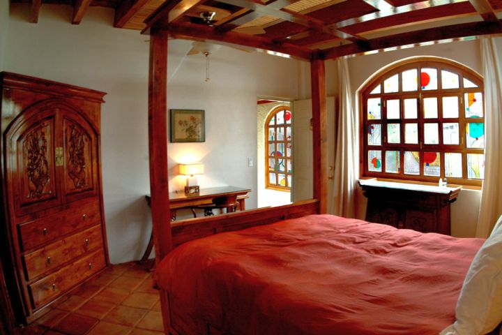 modern asian bedroom with four posts bed and rustic closet