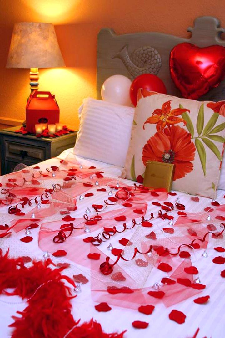most romantic bedrooms with balloon on headboard and flower petals.