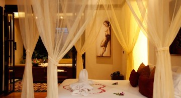 most romantic bedrooms with canopied bed and flower petals