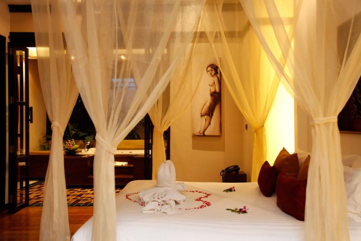 most romantic bedrooms with canopied bed and flower petals