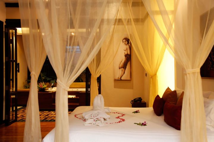 most romantic bedrooms with canopied bed and flower petals