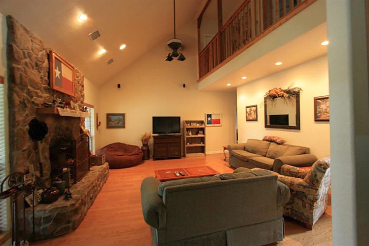 warm and cozy cathedral ceiling living room with fireplace